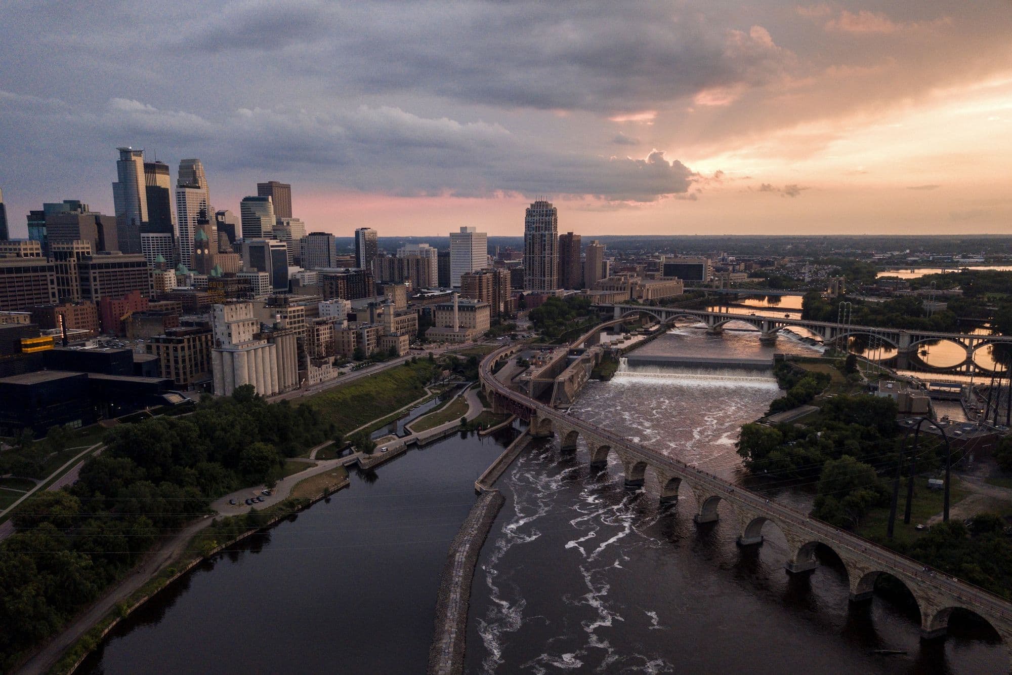 Minneapolis skyline and the Stone Arch Bridge over the Mississippi at dusk