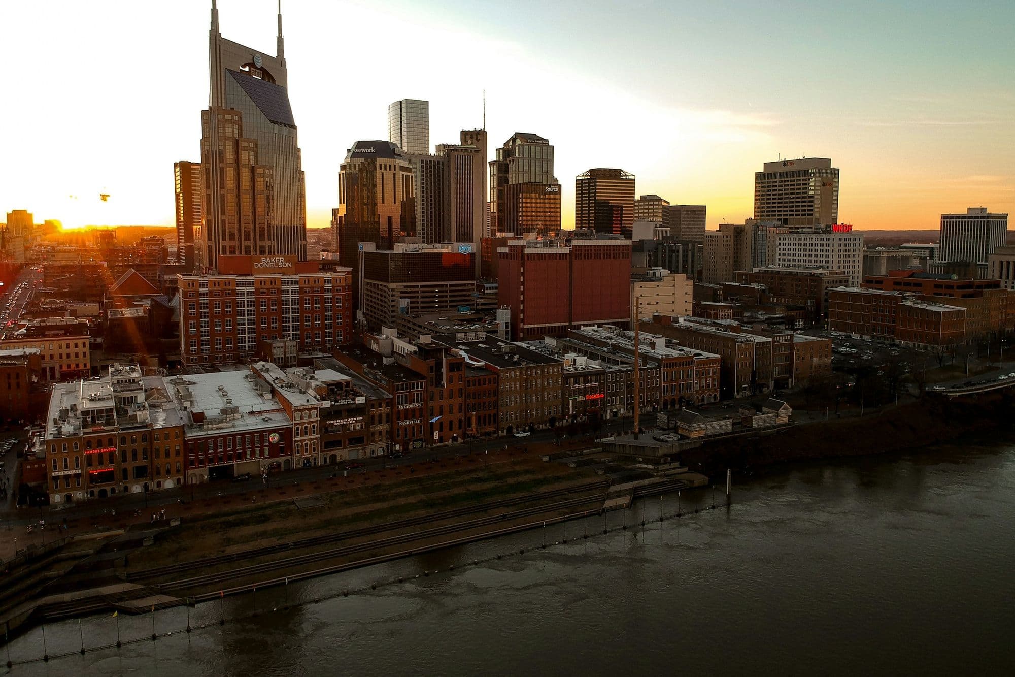Downtown Nashville skyline at sunset over the Cumberland River