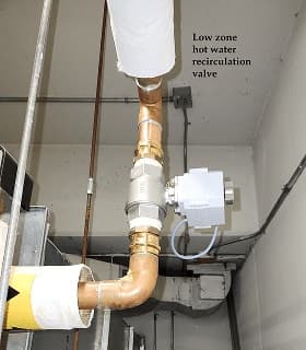 Eddy valve on a low-zone hot-water recirculation line