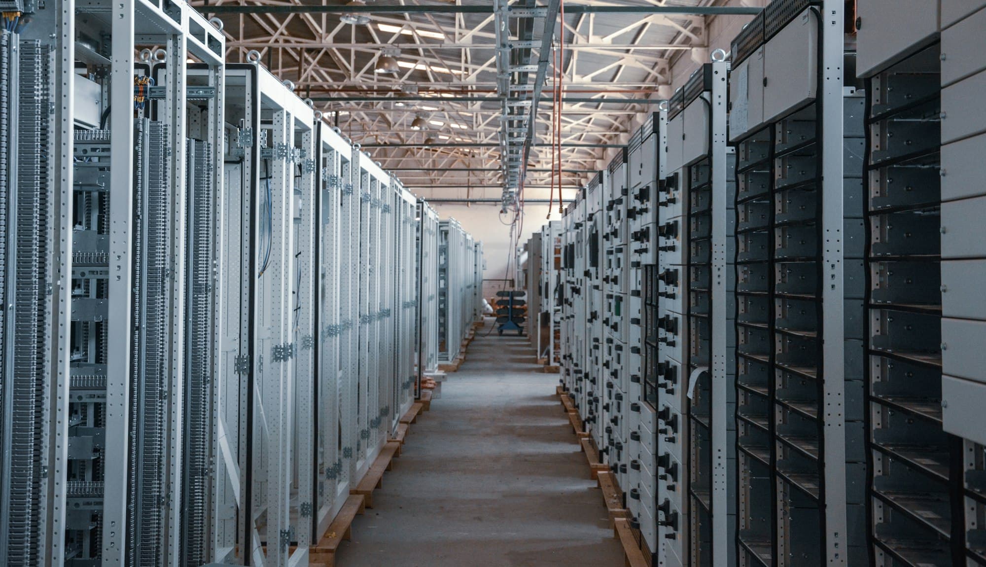 Rows of equipment racks in a data hall during fit-out.