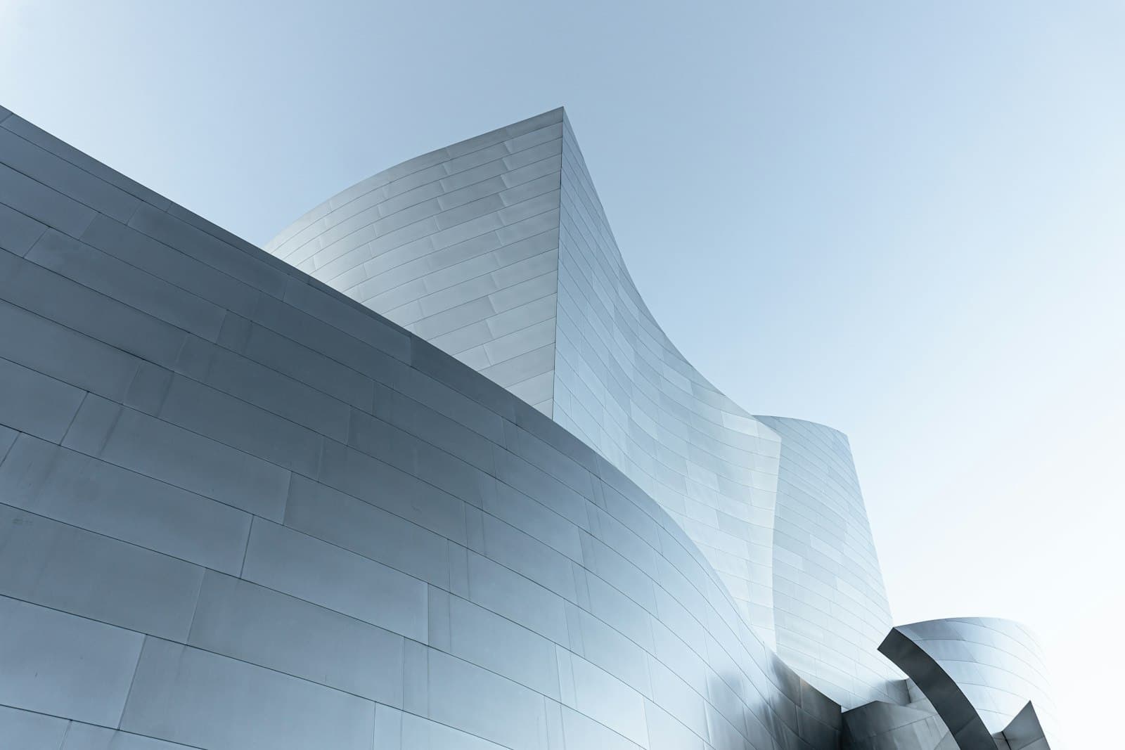Contemporary museum with sweeping curved metallic panels.