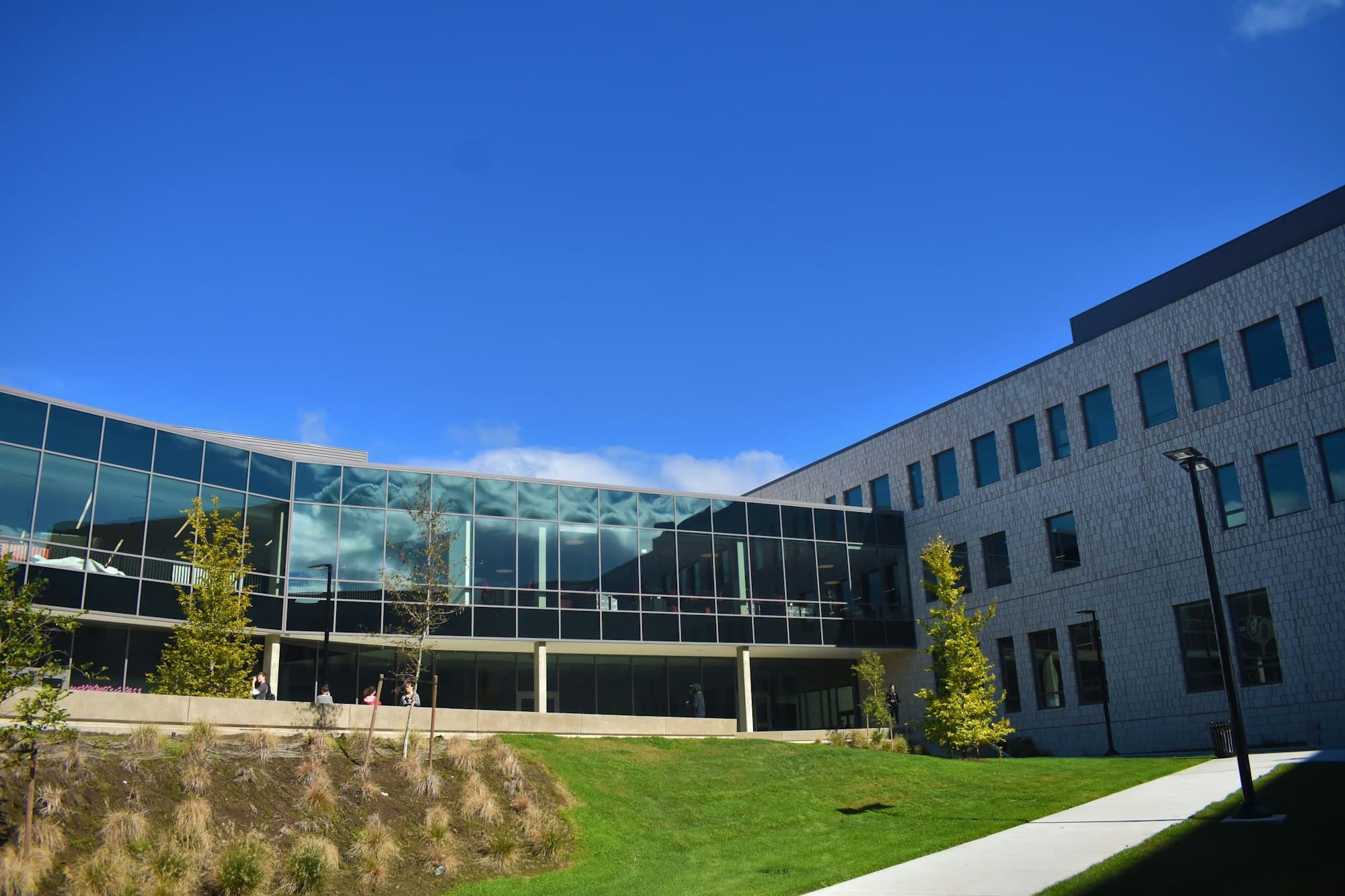 Modern life-sciences research building under a clear sky.